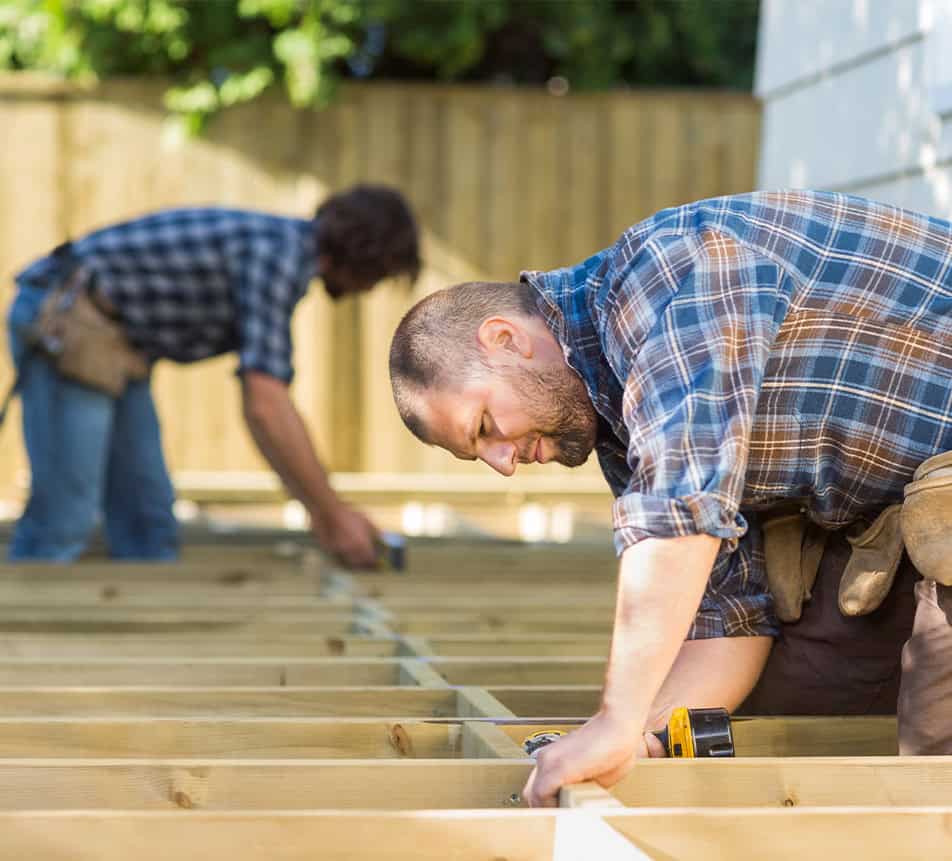 Deck Construction Carpenters Working On Wood Frame
