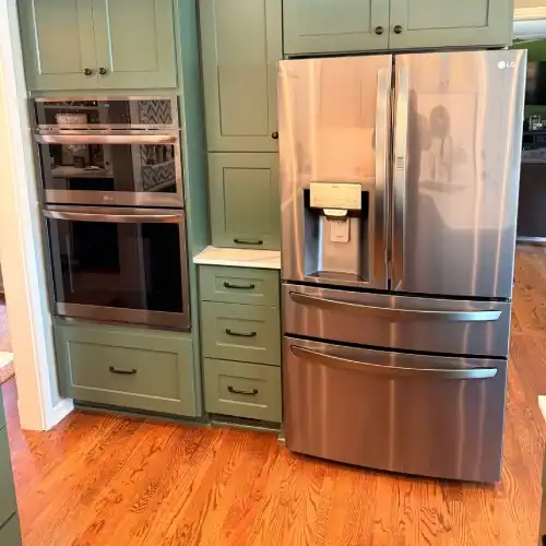 Appliance Wall With French Door Fridge And Double Wall Ovens By Stag Homes In Overland Park, Ks Kitchen remodel Overland Park with built-in double wall ovens, paneled storage drawers, and stainless French-door refrigerator by Stag Homes in Overland Park, KS