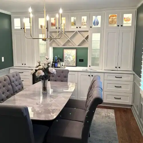 Dining Area With Custom Built Ins And Glass Front Cabinets By Stag Homes In Overland Park, Ks Kitchen remodel Overland Park featuring a dining space with custom built-in cabinets, glass-front uppers, and a modern light fixture by Stag Homes in Overland Park, KS