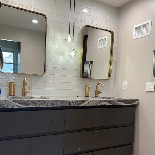 Double Vanity Bathroom Renovation With Brass Fixtures By Stag Homes Design Build In Kansas City Modern double vanity with brass faucets and gray countertop in bathroom renovation by Stag Homes Design Build in Kansas City