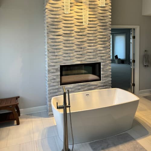 Luxury Bathroom Renovation With Fireplace And Freestanding Tub By Stag Homes Design Build In Kansas City Kansas City bathroom renovation showcasing freestanding tub and modern fireplace accent wall by Stag Homes Design Build