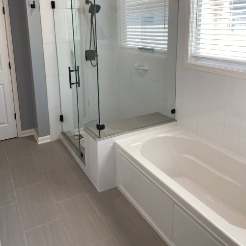 Sleek Shower And Built In Bathtub Remodel By Stag Homes Design Build In Kansas City Modern Kansas City bathroom renovation with glass shower and built-in tub by Stag Homes Design Build